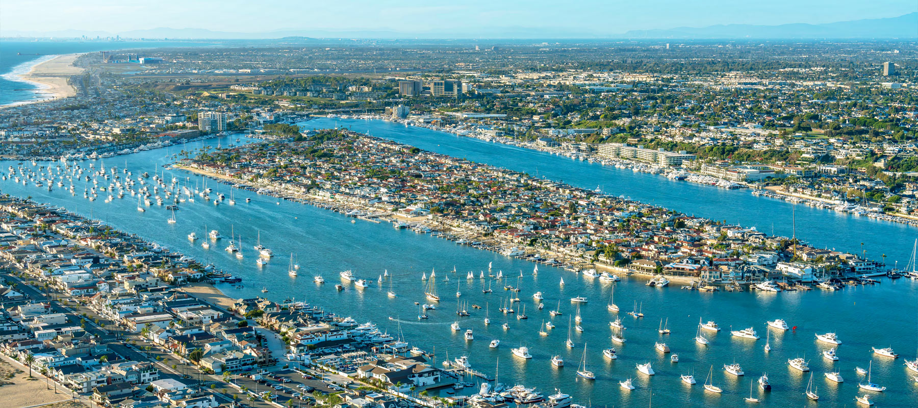 Aerial view of  Lido Isle and Newport Beach harbor filled with boats