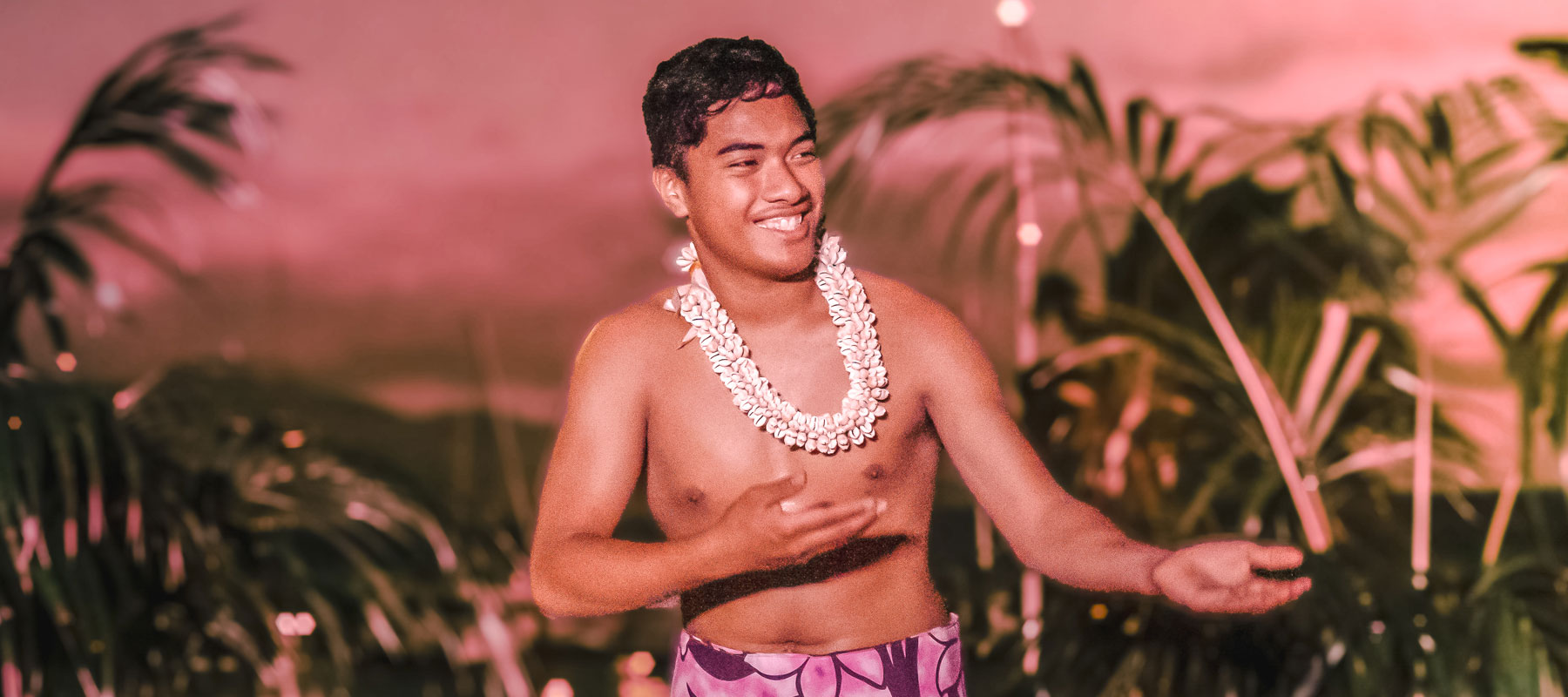Polynesian male dancer welcoming guests at the Maui Luau Experience