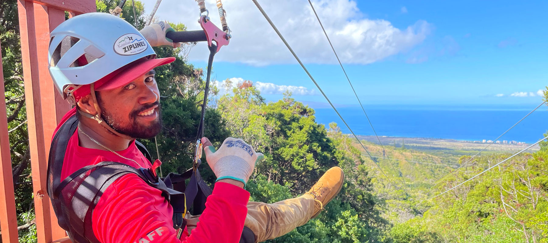 Guest secured in zipline harness ready to launch on Maui zipline course