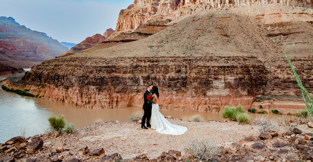 Bride and groom embrace their love amidst the stunning Grand Canyon backdrop