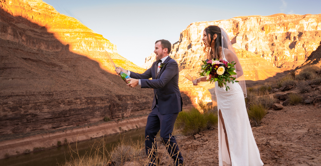 A beautiful couple celebrates their love with a champagne toast during the Desert Dreams Grand Canyon wedding