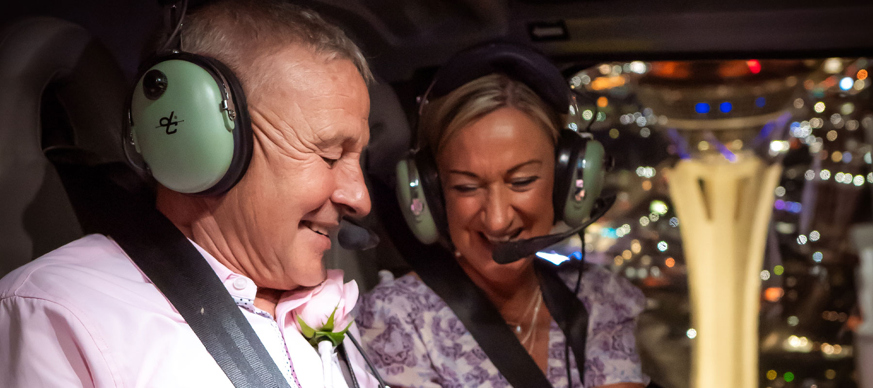 A couple enjoying the view from inside the helicopter during their Vegas Reflection wedding flight